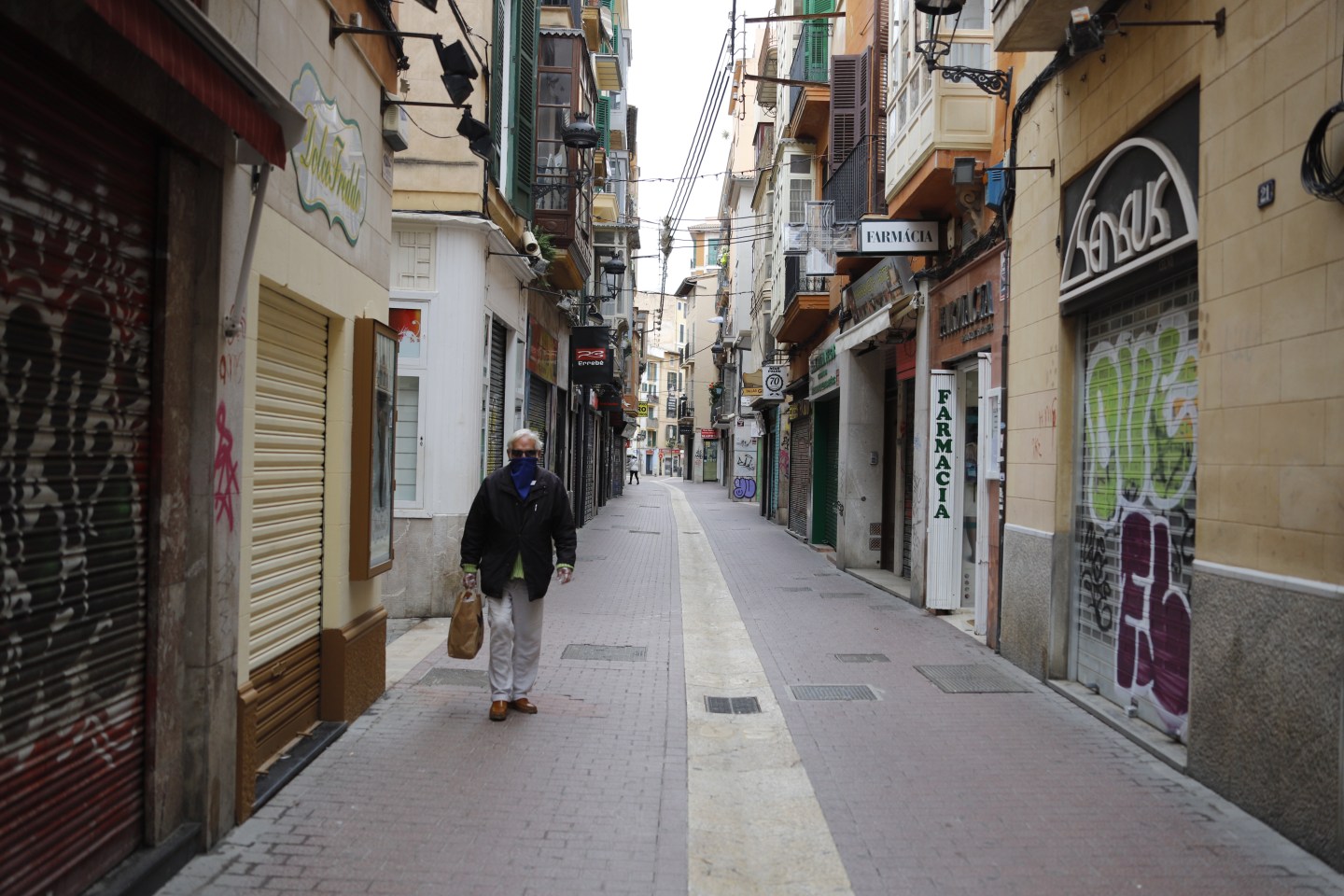 Man walking alone down street in Spain