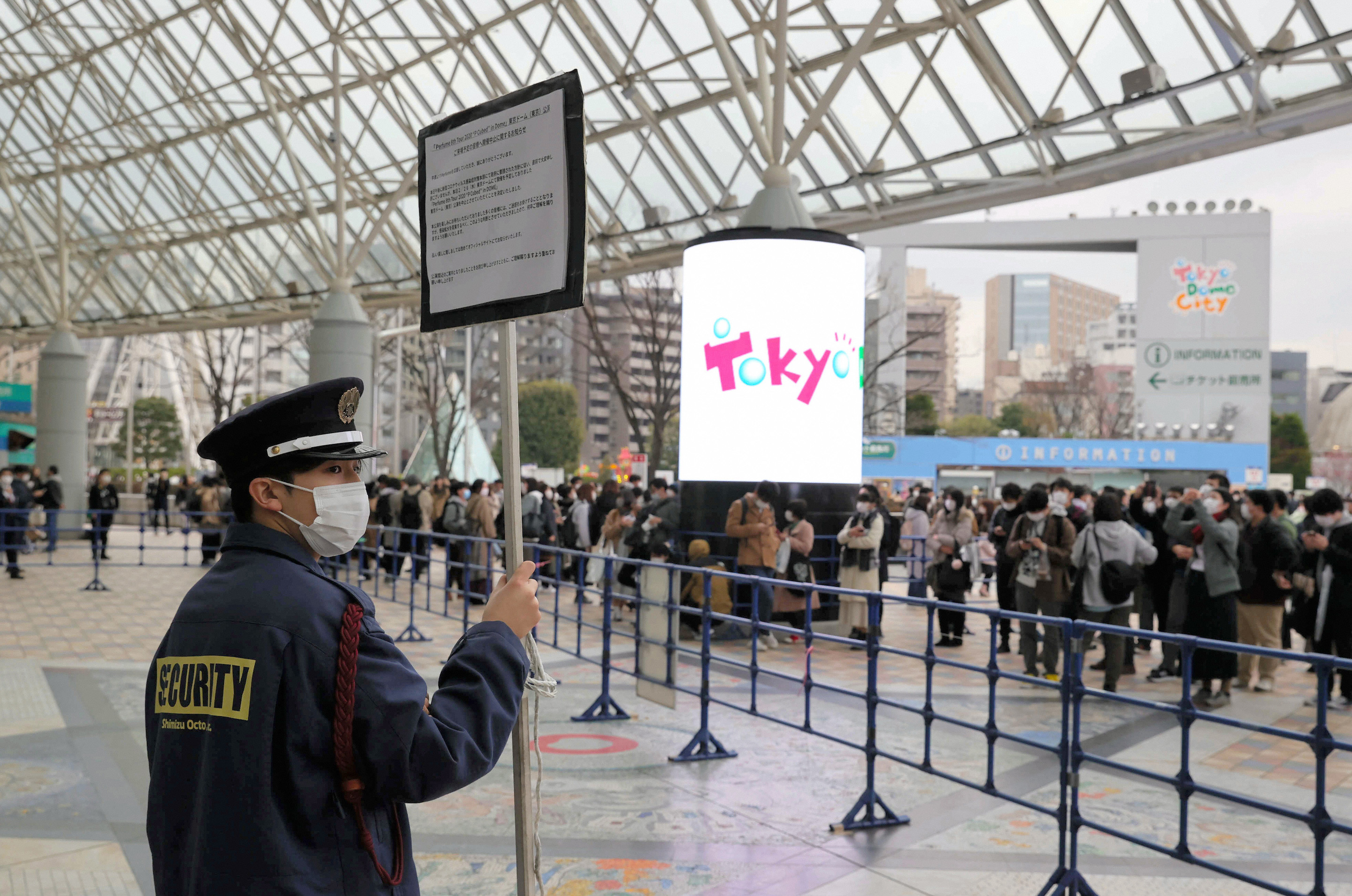 A security staff stands with a sign to inform cancellation of the concert of the pop group Perfume on February 26, 2020 in Tokyo, Japan.