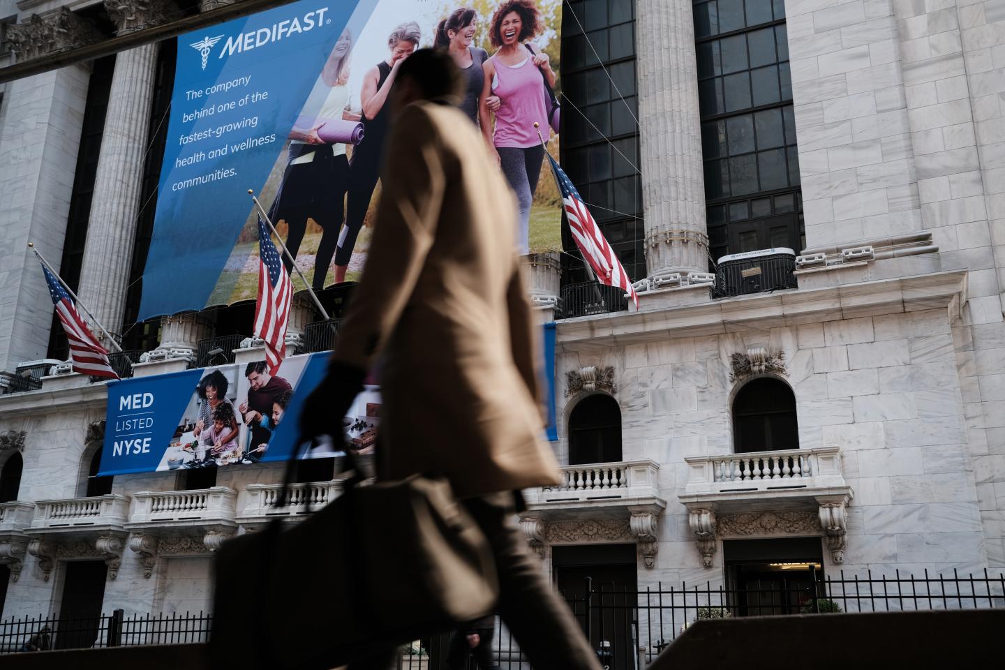 NEW YORK, NEW YORK - MARCH 02: People walk past the New York Stock Exchange (NYSE) on March 02, 2020 in New York City. Stocks were up slightly in morning trading following a week that saw a massive sell off due to fears over the Coronavirus. (Photo by Spencer Platt/Getty Images)