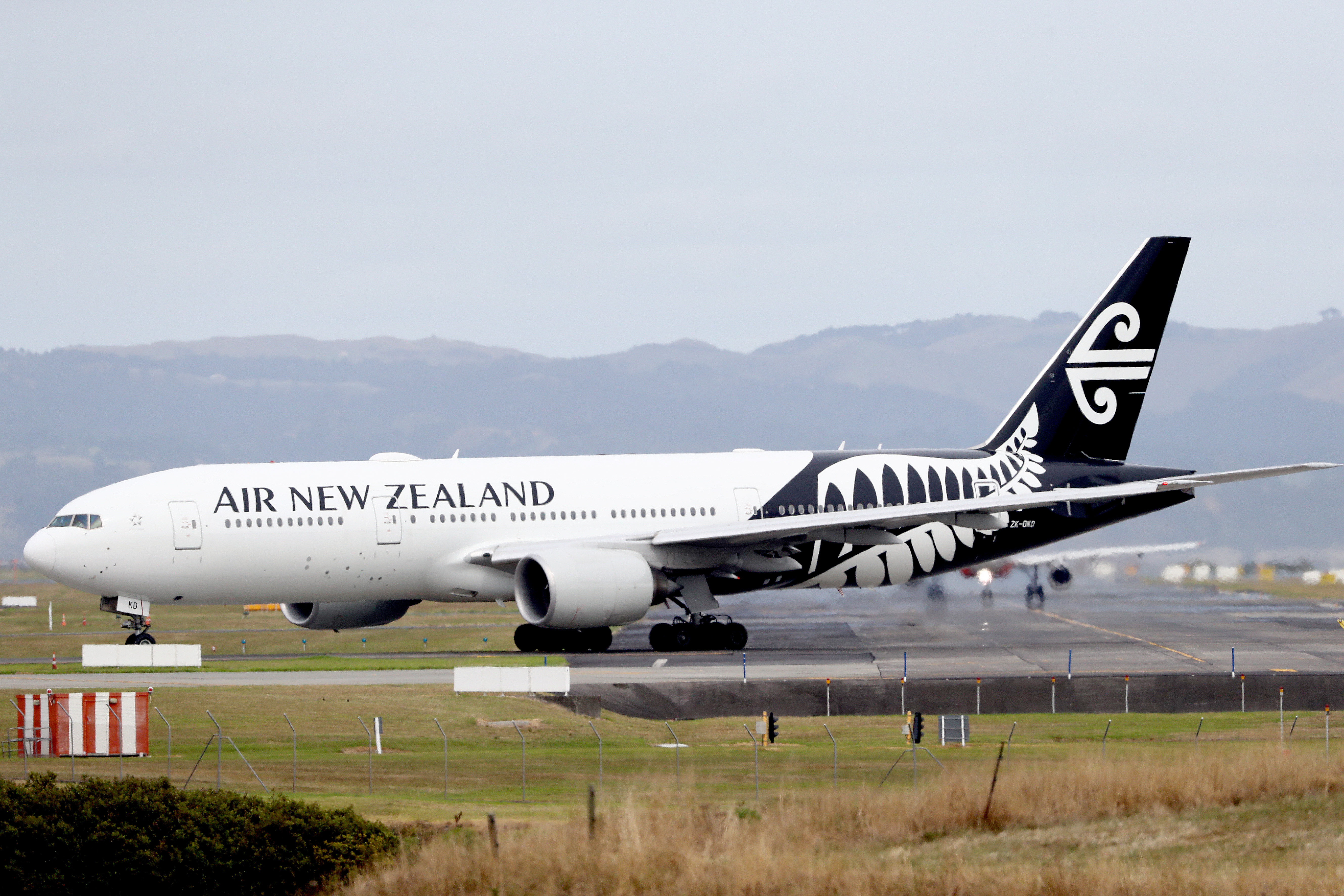 AUCKLAND, NEW ZEALAND - MARCH 16: An Air New Zealand plane is seen at Auckland Airport on March 16, 2020 in Auckland, New Zealand. Air New Zealand has announced it will reduce its international capacity by 85 per cent as a result of the current coronavirus pandemic and its impact on travel demand. The airline is suspending flights between Auckland and Chicago, San Francisco, Houston, Buenos Aires, Vancouver, Tokyo Narita, Honolulu, Denpasar and Taipei from 30 March to 30 June. It is also suspending its London–Los Angeles service from 20 March through to 30 June. Air New Zealand's Tasman and Pacific Island network capacity will significantly reduce between April and June, while domestic route capacity will be reduced by around 30 percent in April and May. (Photo by Hannah Peters/Getty Images)