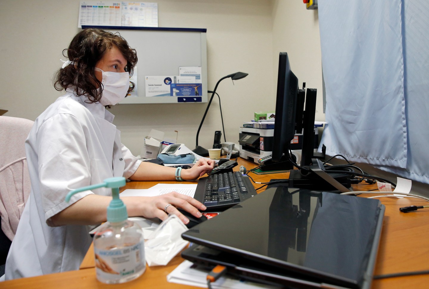 French doctor at computer terminal
