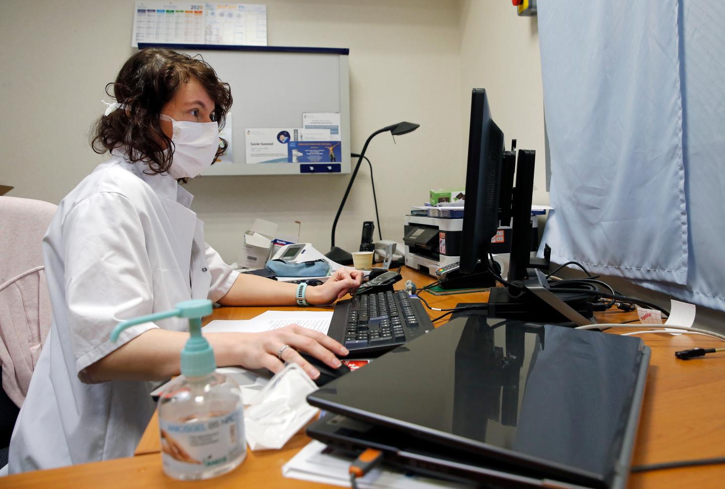 French doctor at computer terminal