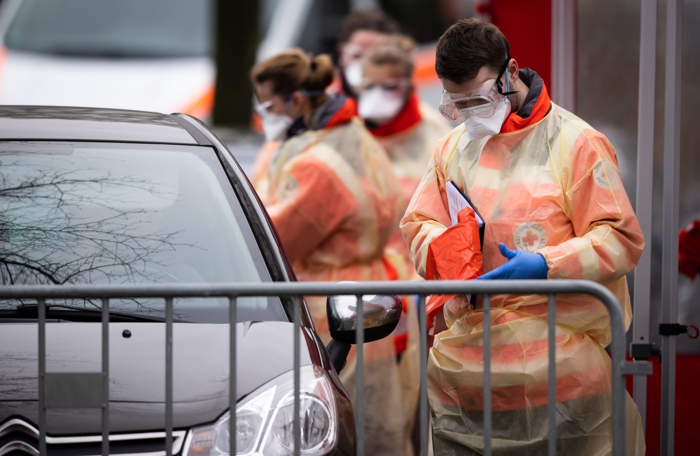 OBERHAUSEN, GERMANY - MARCH 20: A medical worker takes personal informations from a motorist at a drive-in testing facility for people with possible coronavirus symptoms on March 20 in Oberhausen, Germany. Everyday life in Germany has become fundamentally altered as authorities tighten measures to stem the spread of the coronavirus. Public venues such as bars, clubs, museums, cinemas, schools, daycare centers and universities have closed.