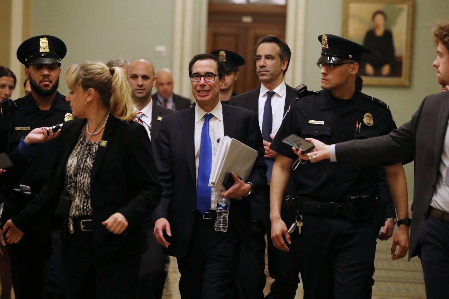 WASHINGTON, DC - MARCH 24: Treasury Secretary Steven Mnuchin (C) leaves the offices of Minority Leader Charles Schumer (D-NY) as negotiations continue into the night on a $2 trillion economic stimulus in response to the coronavirus pandemic at the U.S. Capitol March 24, 2020 in Washington, DC. After days of tense negotiations -- and Democrats twice blocking the nearly $2 trillion package -- the Senate and Treasury Department appear to have reached important compromises on legislation to shore up the economy during the COVID-19 pandemic. (Photo by Chip Somodevilla/Getty Images)