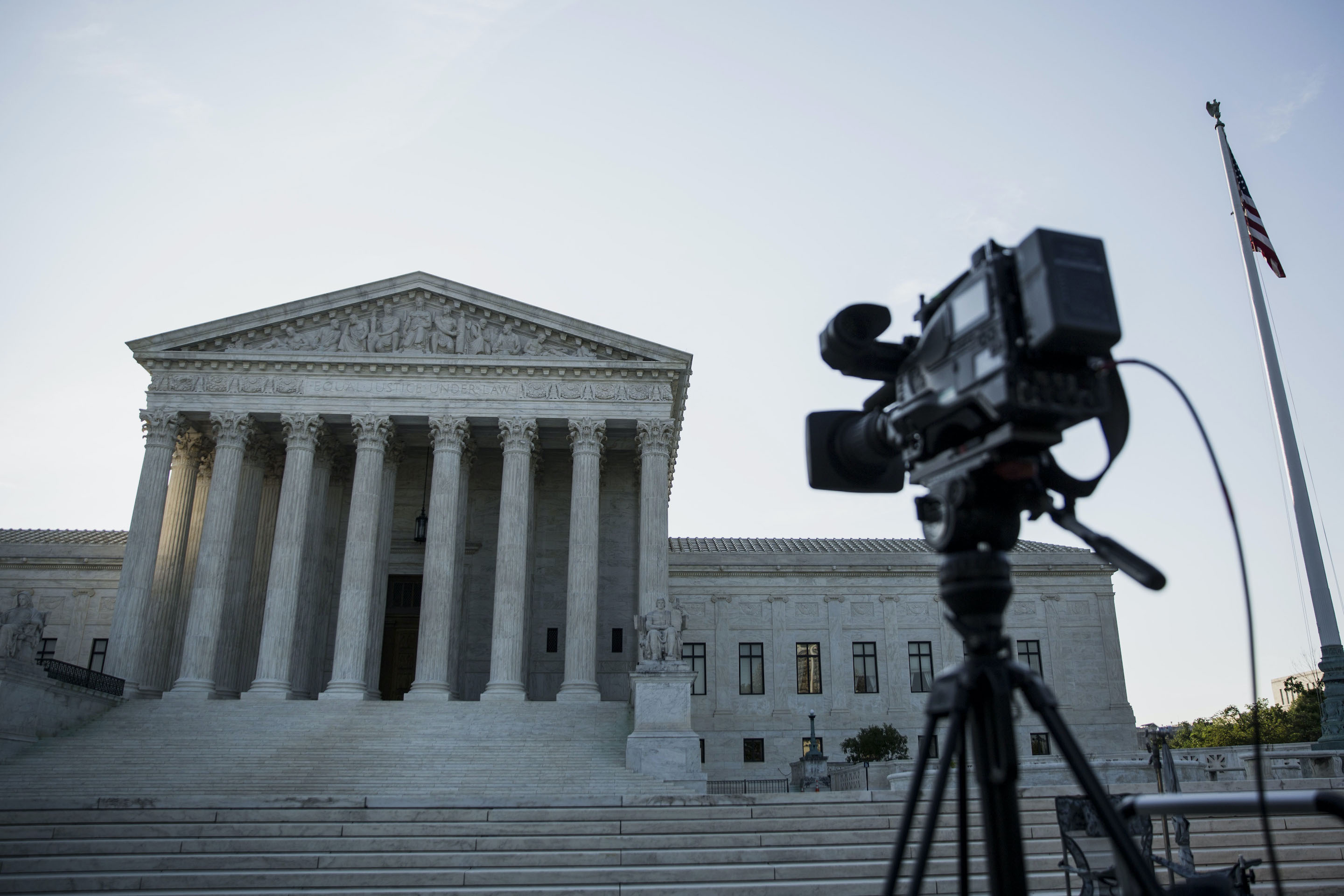 A camera sits on a tripod in front of the U.S. Supreme Court in Washington, D.C., on Monday, June 22, 2015. With the coronavirus closing the Supreme Court, some experts think it’s time Chief Justice John Roberts opens up the body to more technology, including streaming video and cameras in the court.