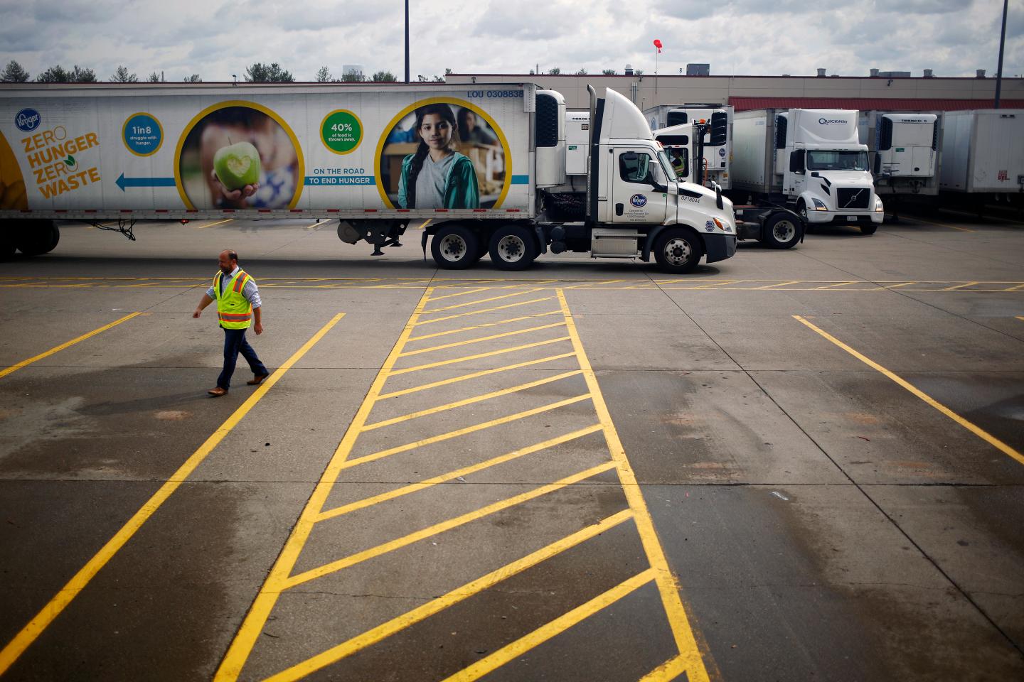 A semi-trailer truck drives through the parking lot of a Kroger Co. grocery distribution center in Louisville, Kentucky on March 20, 2020.