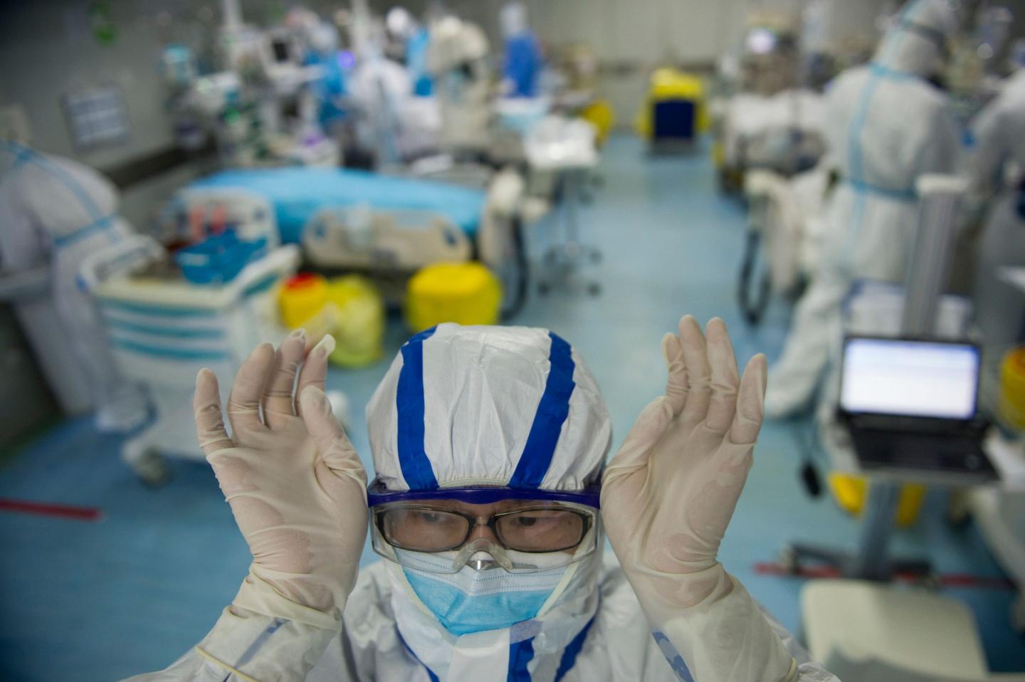 This photo taken on February 22, 2020 shows a nurse adjusting his goggles in an intensive care unit treating COVID-19 coronavirus patients at a hospital in Wuhan, in China's central Hubei province.