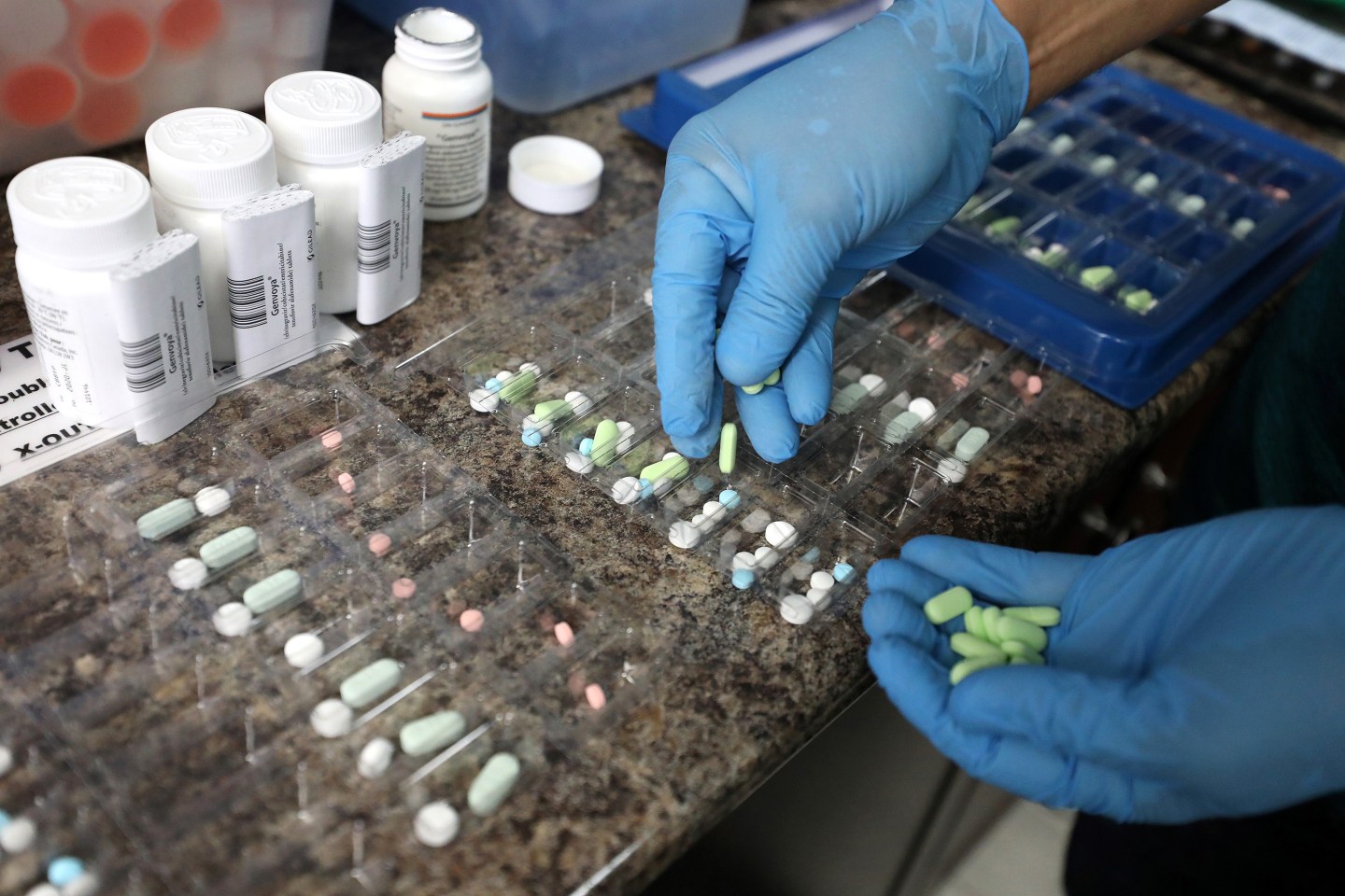 A pharmacist counts prescription drugs at the at the CentreTown Pharmacy.