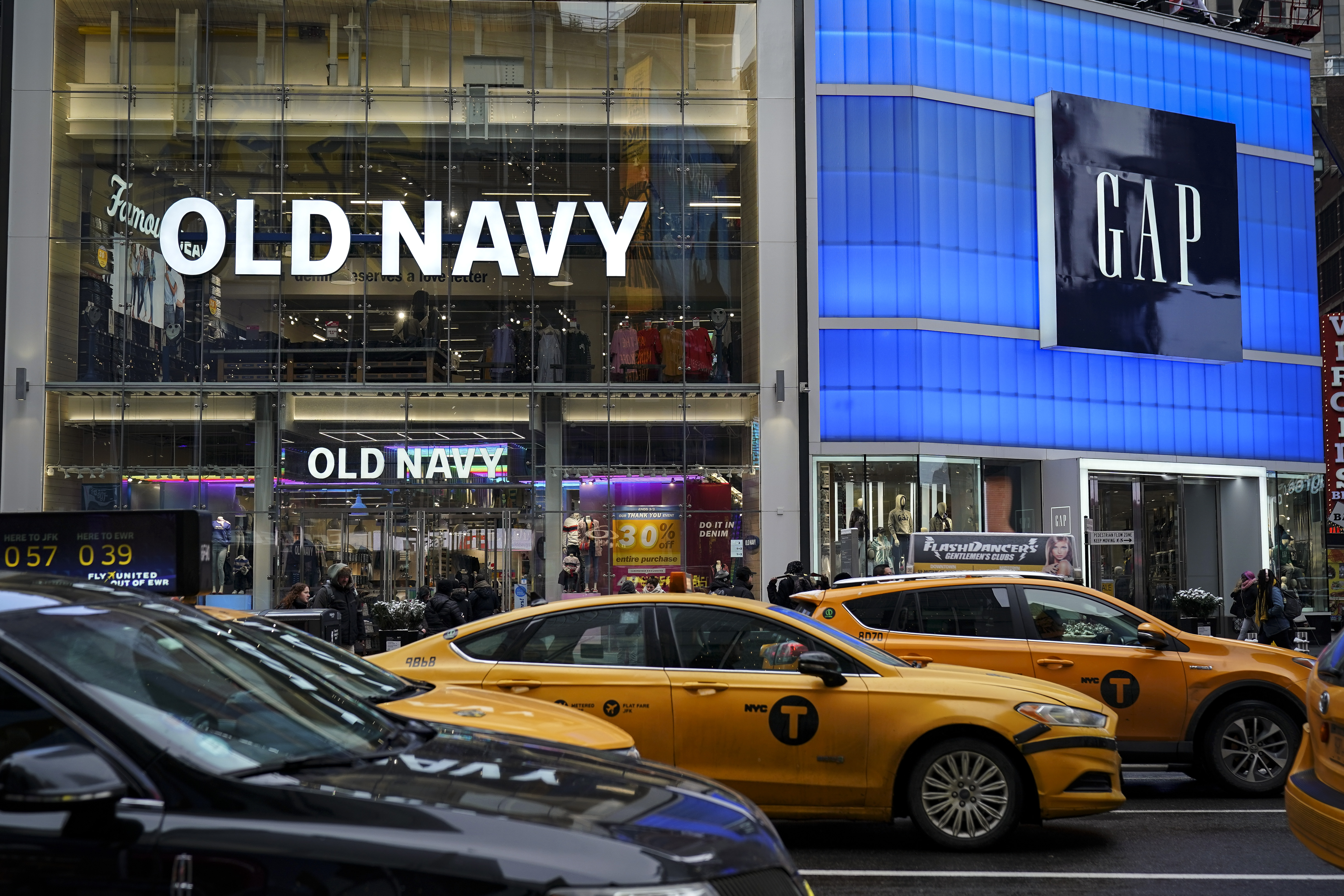 Traffic passes by an Old Navy and Gap stores in Times Square, March 1, 2019 in New York City. 
