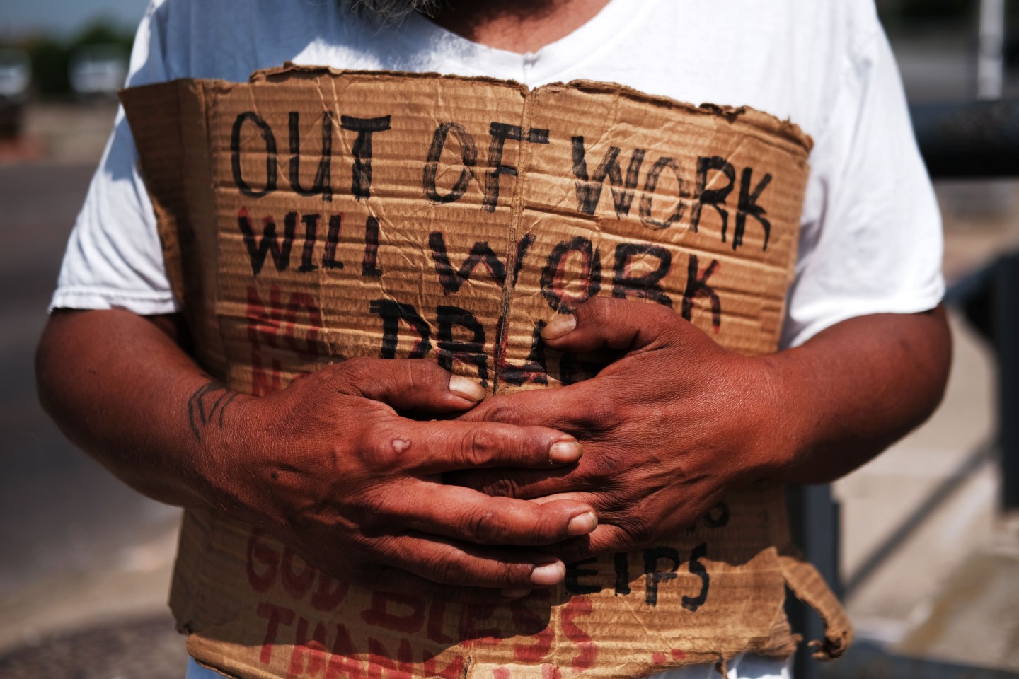 LAWRENCE, MASSACHUSETTS - AUGUST 16: George, who is homeless, panhandles along a street in Lawrence on August 16, 2019 in Lawrence, Massachusetts. Lawrence, once one of America’s great manufacturing cities with immigrants from around the world coming to work in its textile and wool processing mills, has struggled to find its economic base since the decline of manufacturing. Despite a strong national economy, Lawrence, and many mid-size American cities and towns, are struggling with persistent joblessness, an opioid epidemic and a lack of affordable housing. While Lawrence is witnessing pockets of investment, many of its residents are facing economic hardship. Currently one-third of Lawrence's children live in poverty, 36 percent of residents receive aid under the Supplemental Nutrition Assistance Program and just over 24 percent of residents live in poverty. (Photo by Spencer Platt/Getty Images)