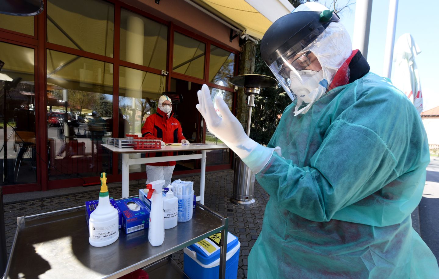 A medical staff member with protective equipment prepare samples at a drive-through testing point in an effort to curb the spread of COVID-19 (novel coronavirus) next to the Croatian Institute for Public Health, in Zagreb, Croatia, on April 1, 2020. (Photo by Denis LOVROVIC / AFP) (Photo by DENIS LOVROVIC/AFP via Getty Images)