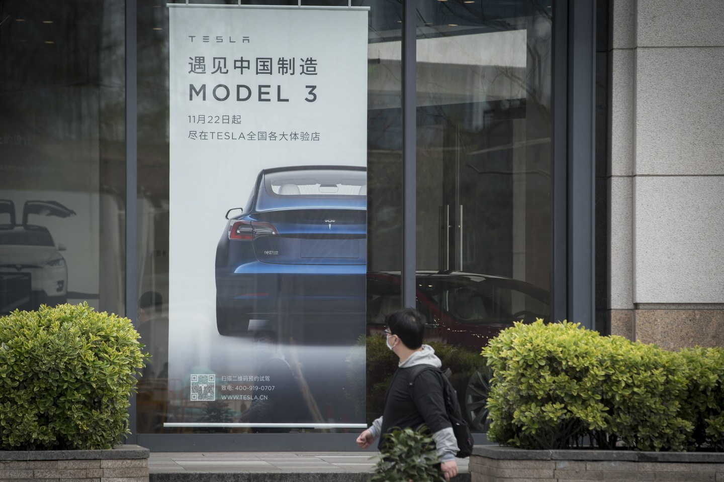An advertisement for the Tesla Model 3 is displayed at a Tesla Inc. dealership in Shanghai, China on Monday, April 6, 2020. China, the biggest market for electric cars, is considering a reduction in rebates given to buyers and limits on the models that qualify even as it commits to extending the costly subsidy program for another two years. Photographer: Qilai Shen/Bloomberg via Getty Images