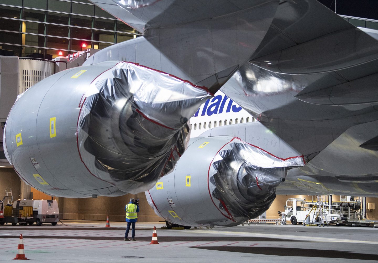 08 April 2020, Hessen, Frankfurt/Main: The engines of a Boeing 747 of Lufthansa at Frankfurt Airport are covered with plastic film. Lufthansa has temporarily taken a large part of its fleet out of service because of the corona pandemic.
