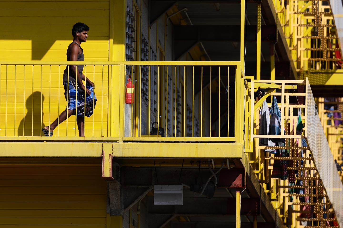 SINGAPORE - APRIL 21: A foreign worker is seen outside his dormitory room on April 21, 2020 in Singapore. Singapore is now battling to control a huge outbreak in the coronavirus (COVID-19) local transmission cases among the migrant workers as it recorded a daily high of 1426 new COVID-19 cases on April 20, bringing the country's total to 8014. (Photo by Suhaimi Abdullah/Getty Images)