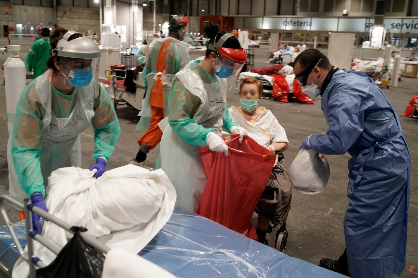 MADRID, SPAIN - MARCH 31: In this handout picture provided by Comunidad de Madrid, patients are seen being transferred from Pavilion 5 to Pavilions 7 and 9 at Emergency Hospital IFEMA on March 31, 2020 in Madrid, Spain. Spain ordered all non-essential workers to stay home for two weeks to help slow the Coronavirus (COVID-19) pandemic, which has killed more than 6,000 people in the country. (Photo by Borja sanchez-trillo - Comunidad de Madrid - Handout/Getty Images)