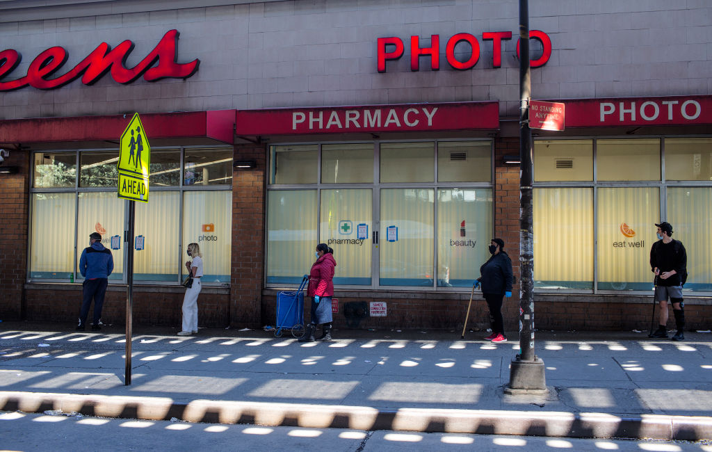 People observing social distancing rules while waiting in line outside a Walgreens Pharmacy in New York City.