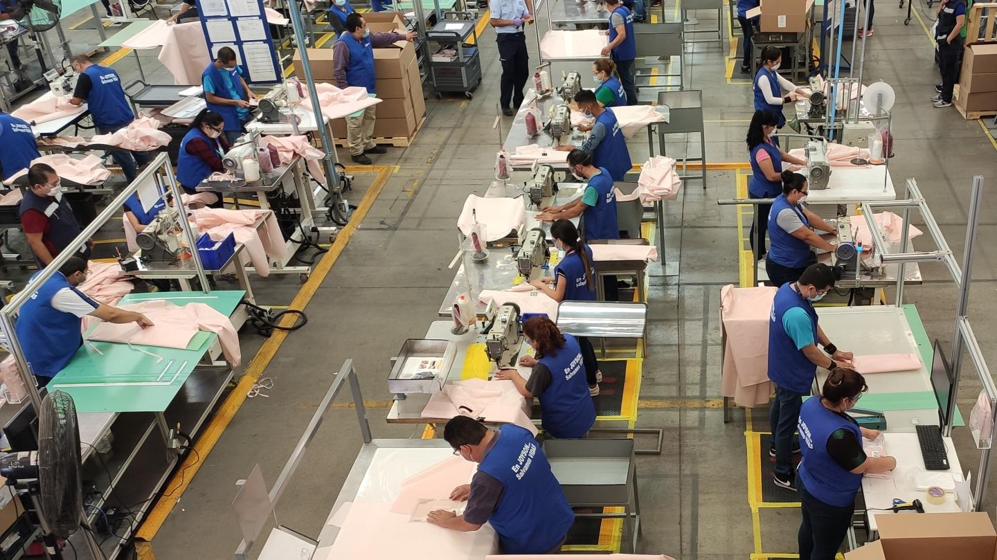 Ford workers making isolation gowns