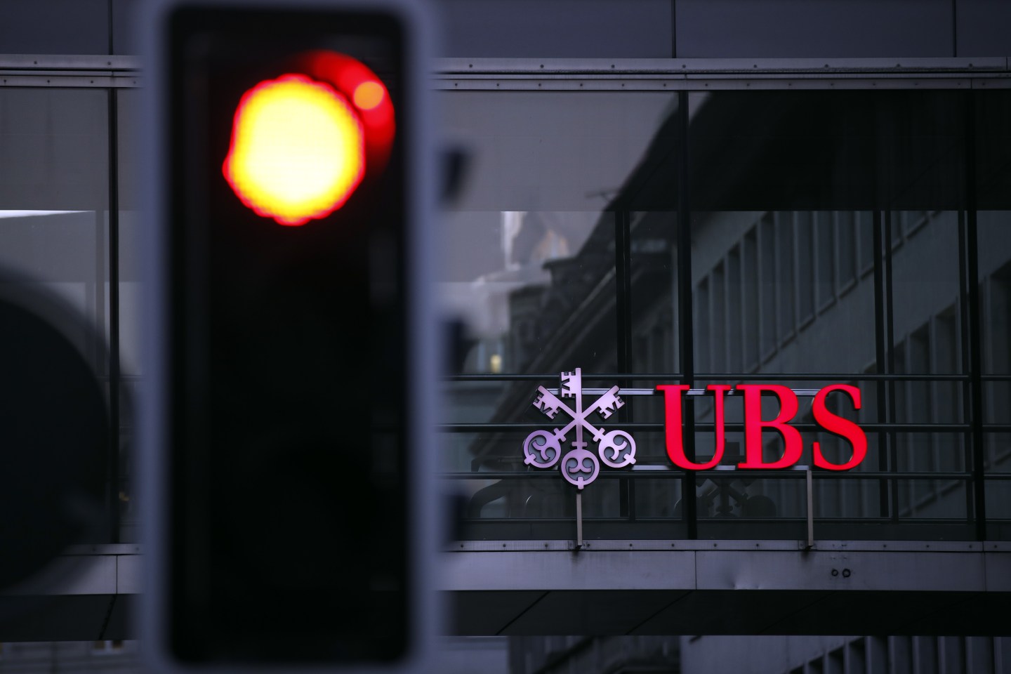 An illumiated company logo is displayed on a walkway at the UBS headquarters in Zurich, Switzerland. The Swiss banking giant is said to be looking to raise a fund targeting fintech investments. Wire photography: Stefan Wermuth—Bloomberg via Getty Images