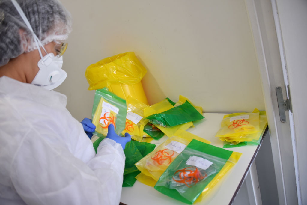 A health worker receives new coronavirus testing kits at the