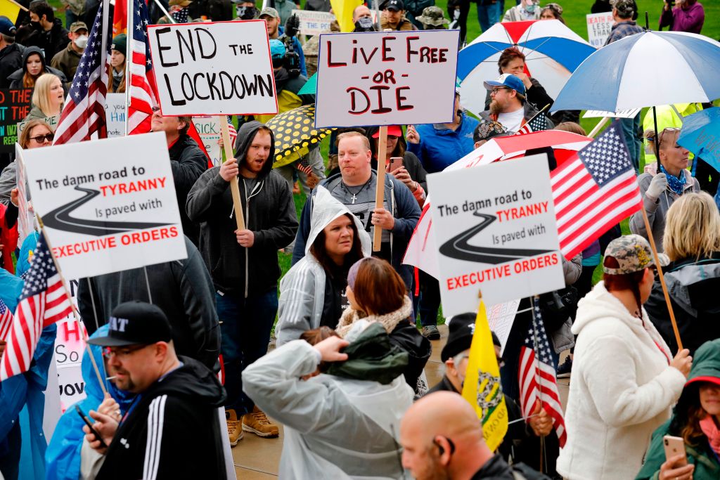 People holding signs demanding an end to the lockdown in Michigan