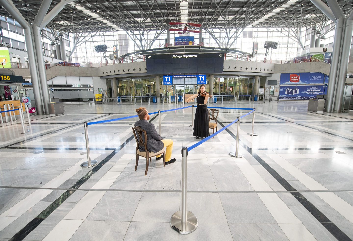dpatop - 04 May 2020, Baden-Wuerttemberg, Stuttgart: Elena Graf, 1st concertmaster of the Stuttgart State Opera, plays for a listener on the violin during the shooting of a trailer for one-to-one concerts of the Stuttgart Opera in Terminal 1 of Stuttgart Airport. The concerts will take place on 8 and 10 May. A musician plays ten minutes each for a single listener. All musicians play free of charge, with the donations of the guests freelance musicians are supported. Photo: Sebastian Gollnow/dpa (Photo by Sebastian Gollnow/picture alliance via Getty Images)