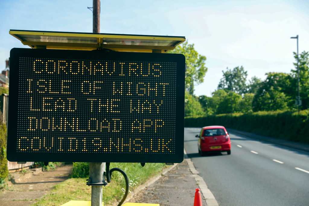 Roadside sign on the Isle of Wight urges motorists to download a coronavirus contact tracing app that the U.K. government is trialing on the island.