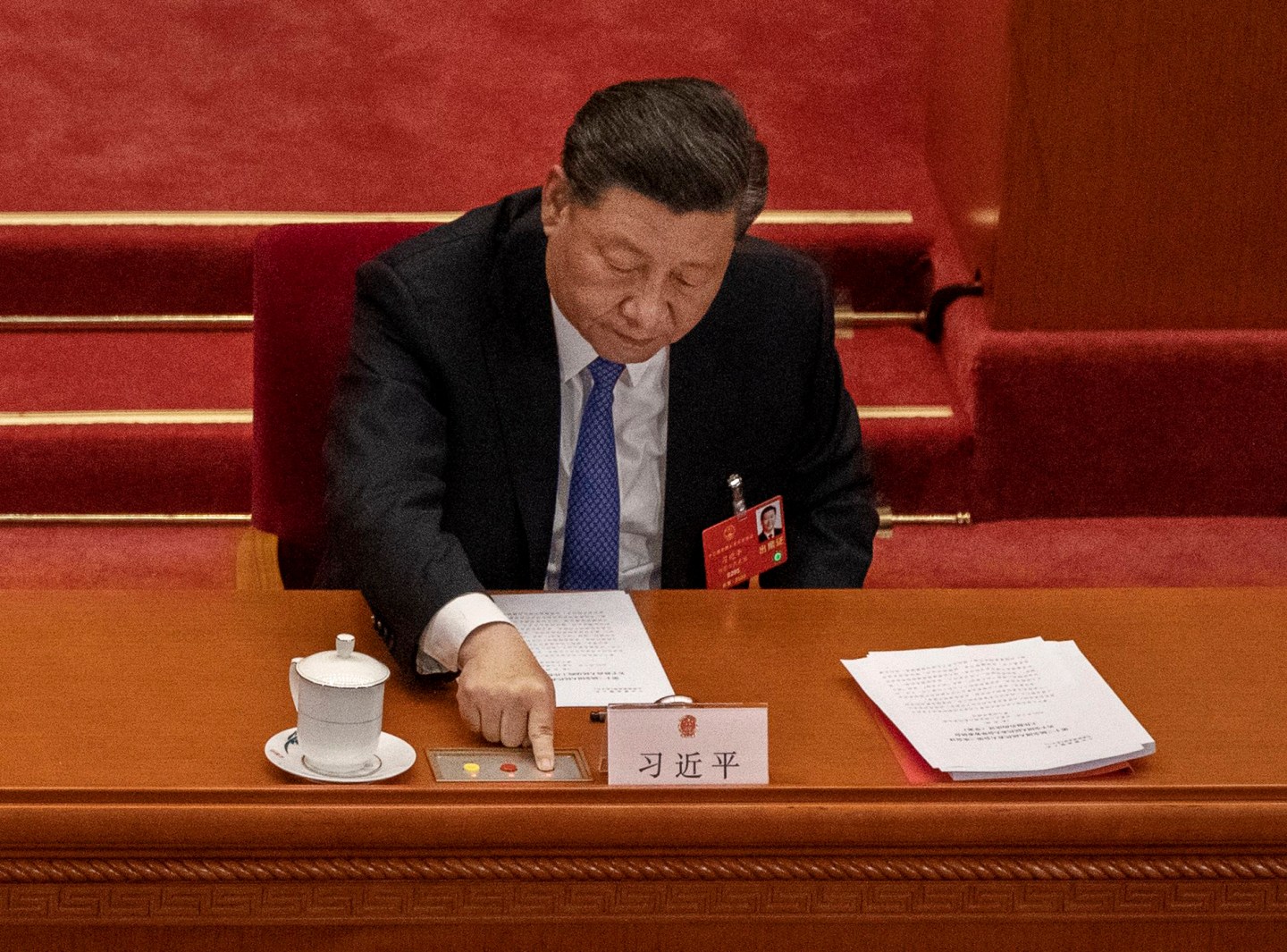Chinese President Xi Jinping, presses the green button as he votes on a new draft security bill for Hong Kong during the closing session of the National People's Congress on May 28, 2020 in Beijing, China.