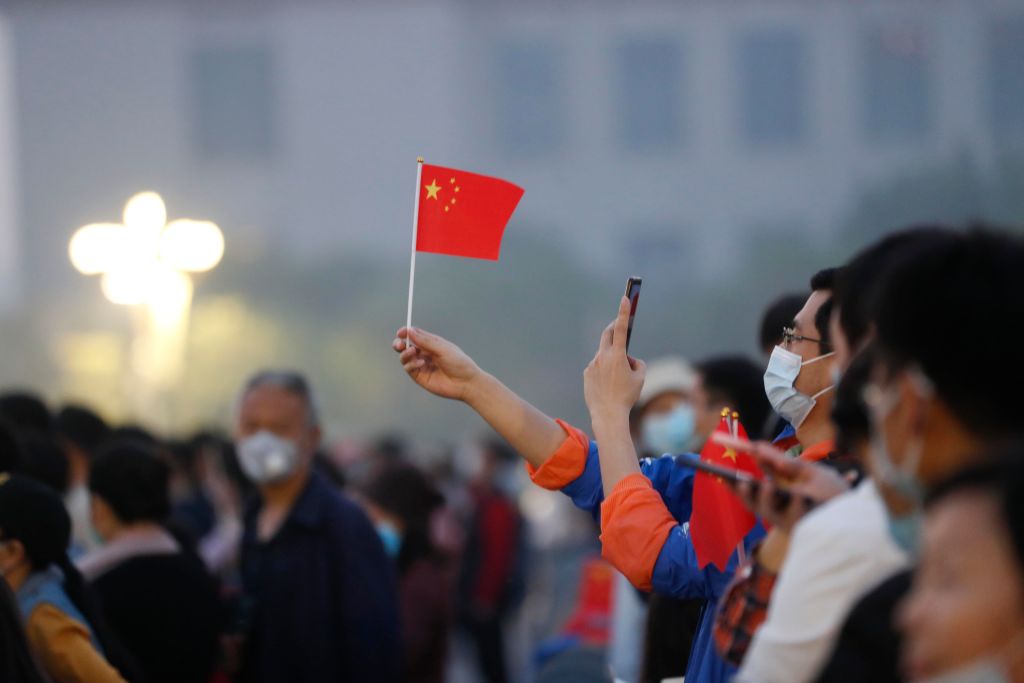 People Watch Flag-Raising Ceremony At Tiananmen Square