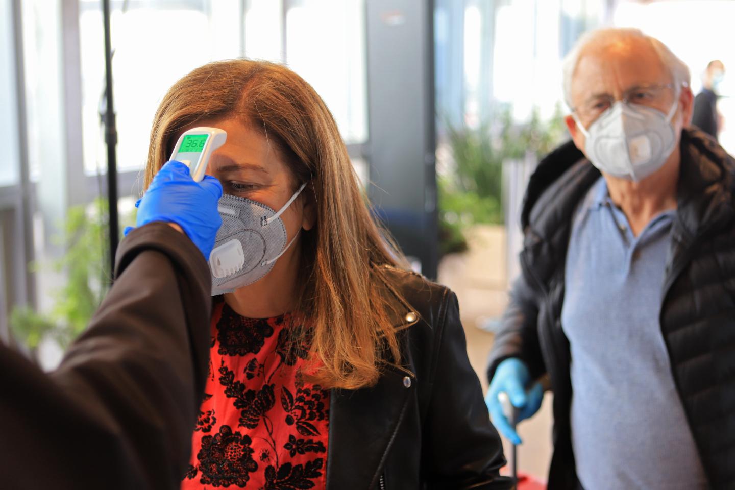 A passenger has her temperature checked before being allowed entry to Ben Gurion Airport on May 14, 2020 near Tel Aviv, Israel. Authorities are preparing for the full reopening of the airport, Israel's main gateway, by June 1, 2020 as coronavirus cases across the country continue to decline. According to reports only visitors from countries with low infection rates and compulsory protective equipment laws will be granted entry while Israelis will need to report to the Health Ministry before traveling abroad.
