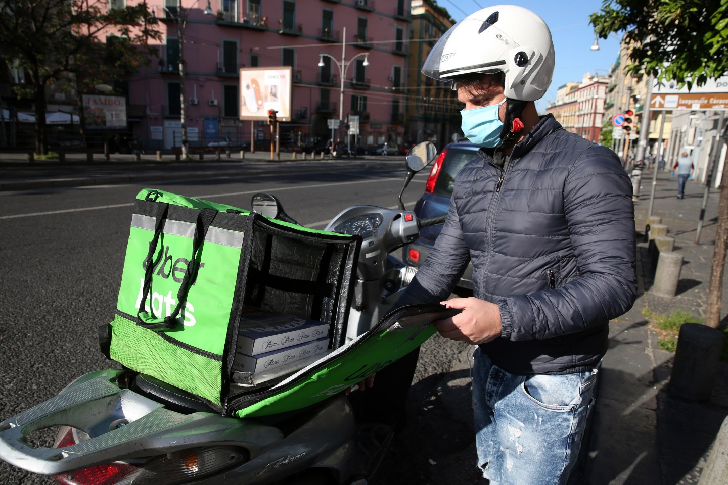 An Uber Eats food delivery rider wearing a protective mask