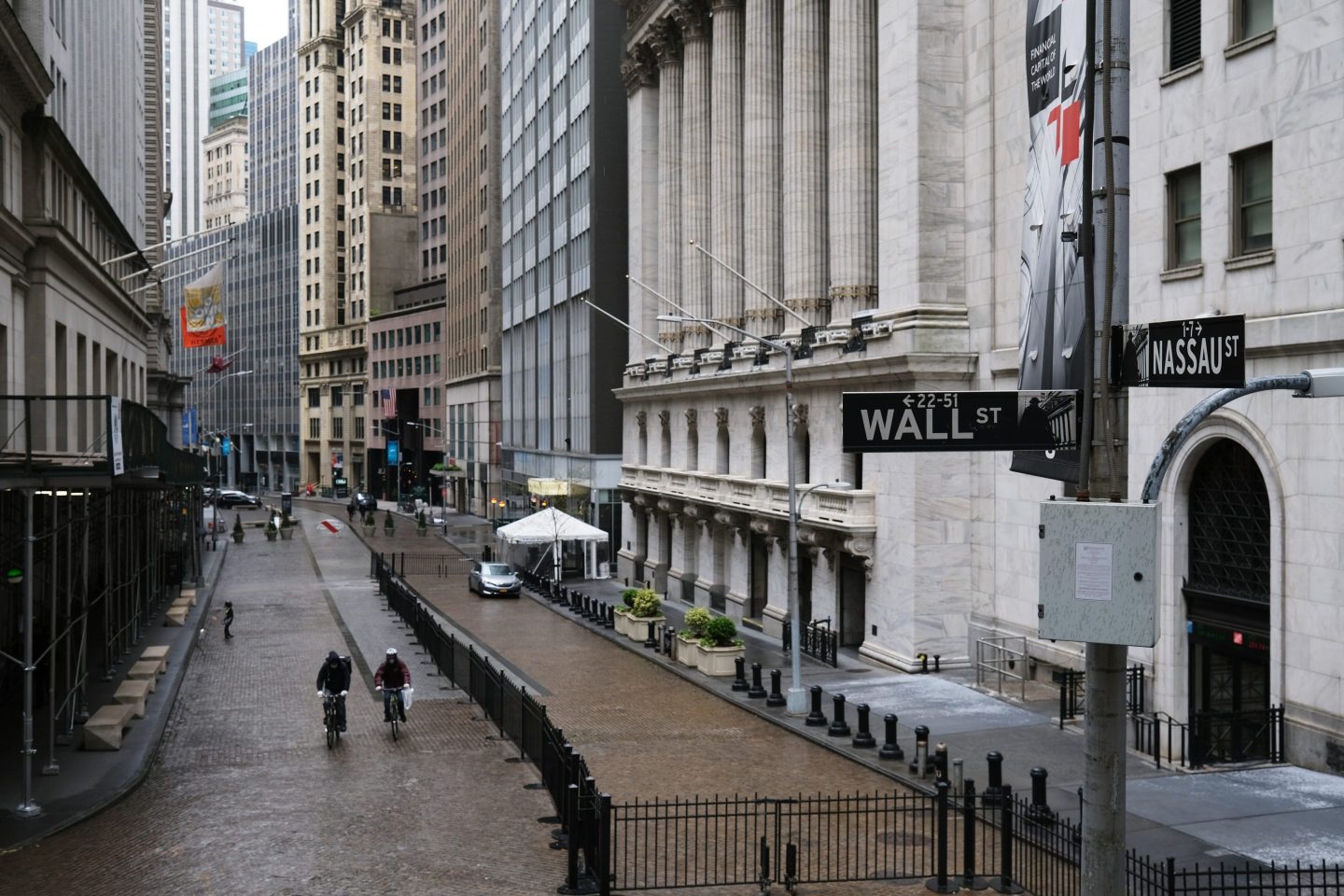 People walk across from the Stock Exchange as the coronavirus keeps financial markets and businesses mostly closed on May 08, 2020 in New York City.