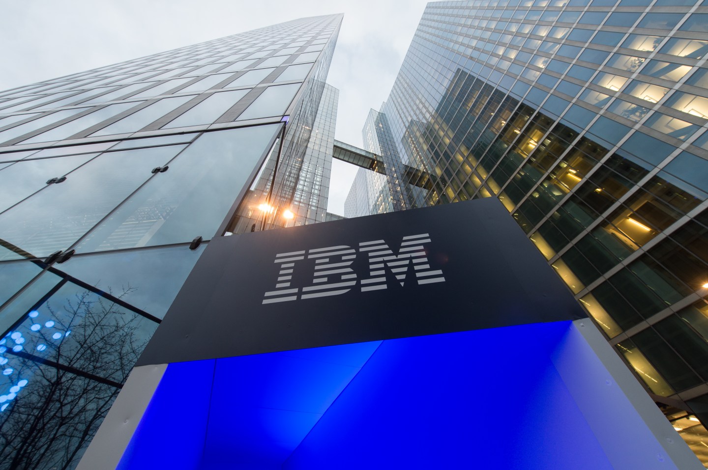 The logo of IBM is seen at the entrance to the Highlight Towers in Munich, Germany, 15 December 2015. Technology corporation IBM opens its worldwide headquarters for its 'Watson IoT' (Internet of Things) division inside the Highlight Towers. Artificial intelligence is to be used to develop new solutions for the IoT.