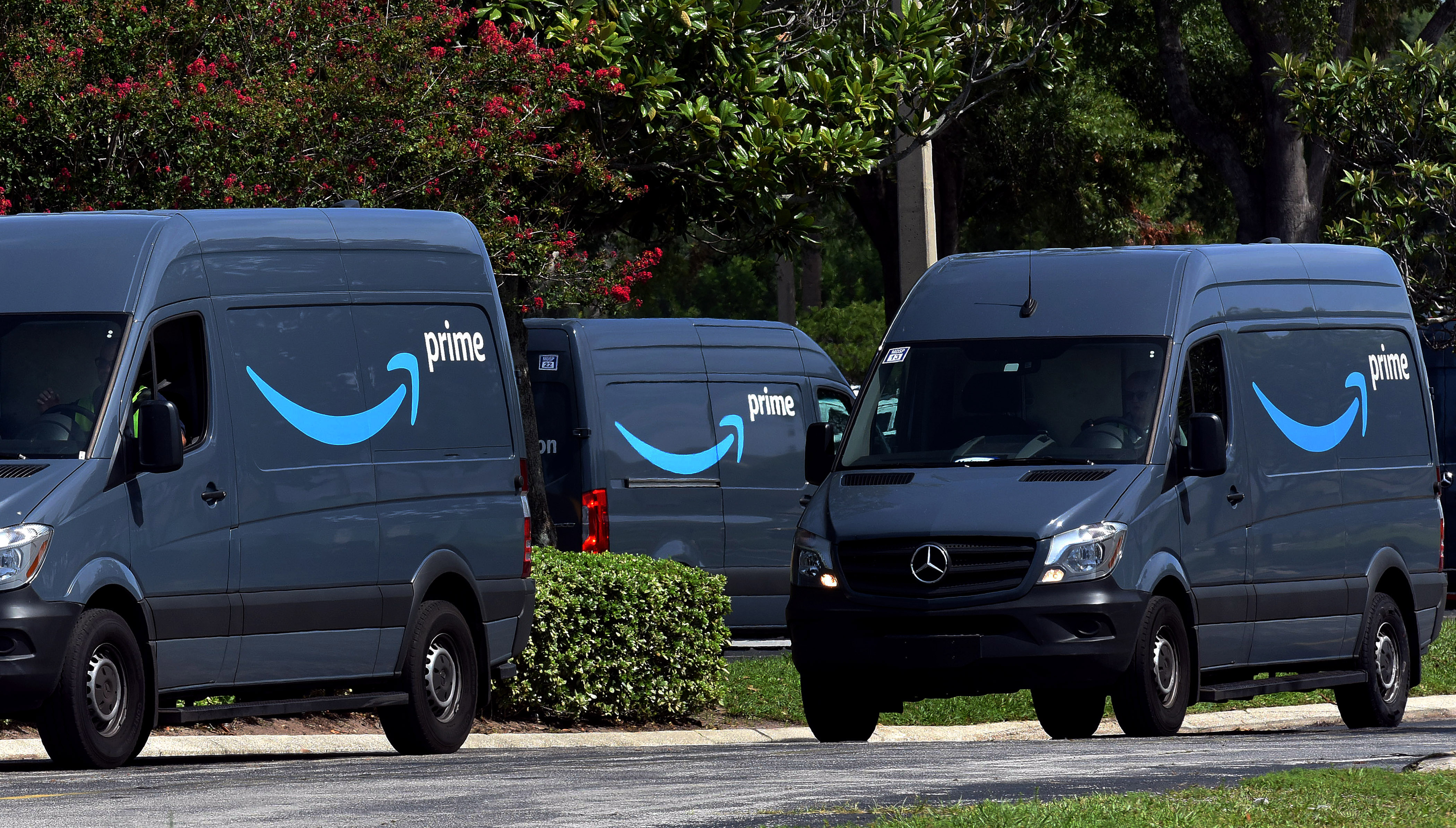 Amazon vans head to a distribution center to pick up packages for delivery on Amazon Prime Day, July 16, 2019, in Orlando.  (Photo by Paul Hennessy/NurPhoto via Getty Images)