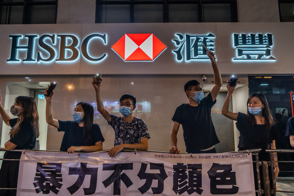 Protesters form a human chain in front of a HSBC bank branch