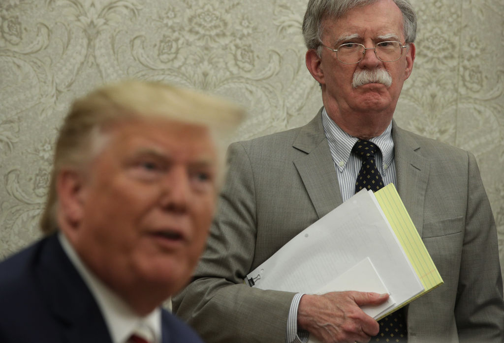 Former National Security Adviser John Bolton listens to President Donald Trump on August 20, 2019 in Washington, DC.
