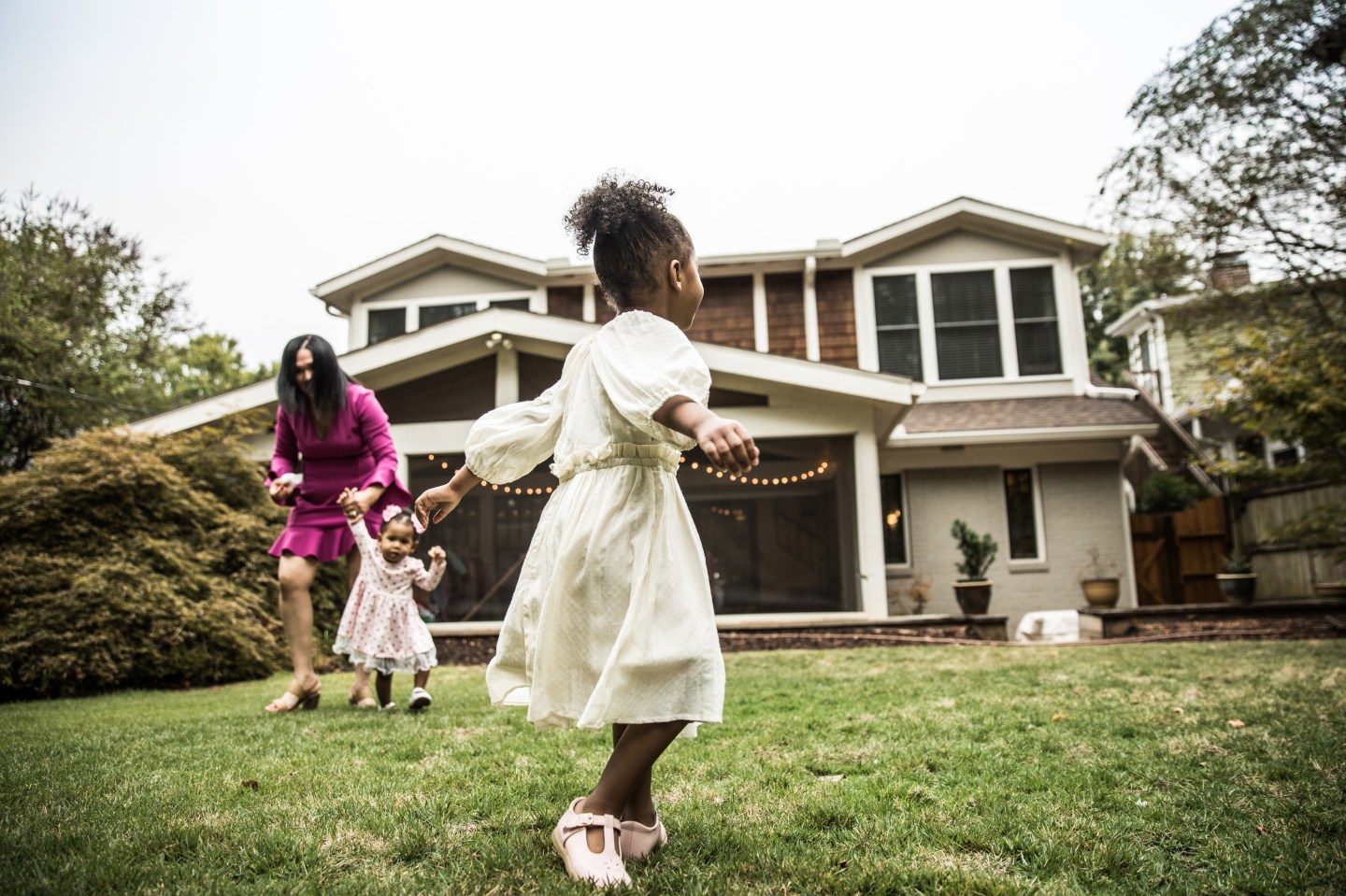 Young girl (3 yrs) playing in backyard