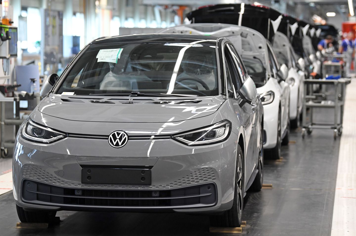 Almost finished Volkswagen ID.3 electric cars are seen at the end of the assembly line at the plant of German car maker Volkswagen (VW) in Zwickau, eastern Germany, after production restarted on April 23, 2020 amid the novel coronavirus COVID-19 pandemic.
