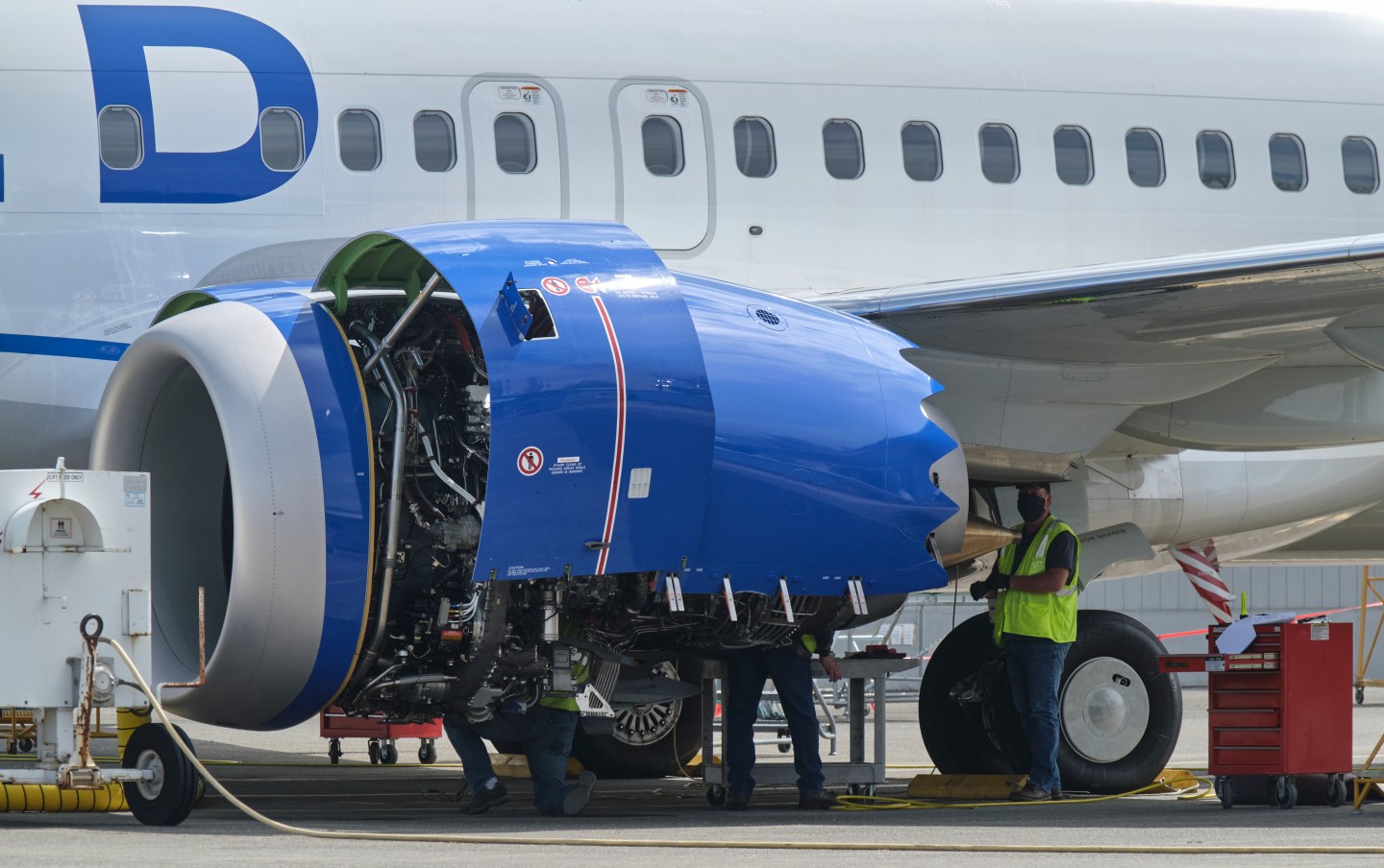An employee works on the engine of a Boeing 737 MAX airplane at the company's factory in Renton, Wash. Boeing is a major client of aerospace firm Woodward. (Photo by Stephen Brashear/Getty Images)