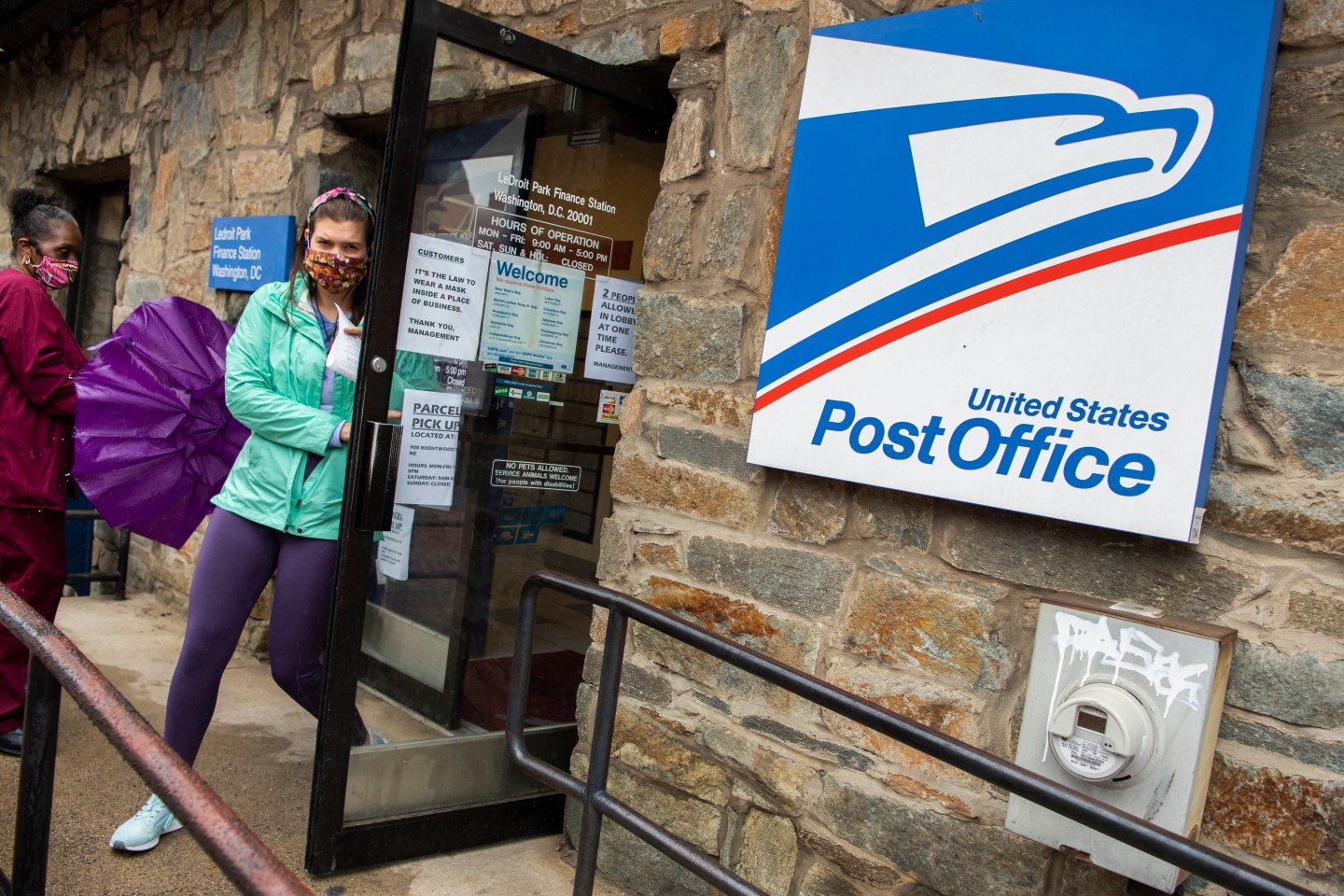 Customers practice the limit of two people at a time in the LeDroit Park Post Office due to the COVID-19 pandemic on Florida Avenue NW, on Thursday, May 28, 2020.