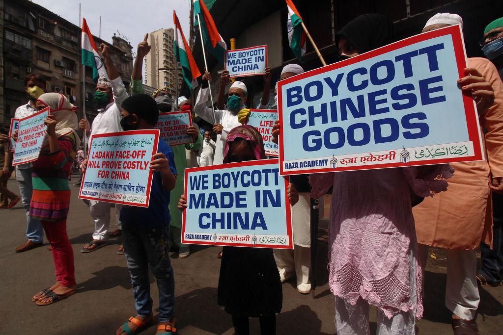Photo of protestors in Mumbai holding signs calling for a ban on Chinese goods.