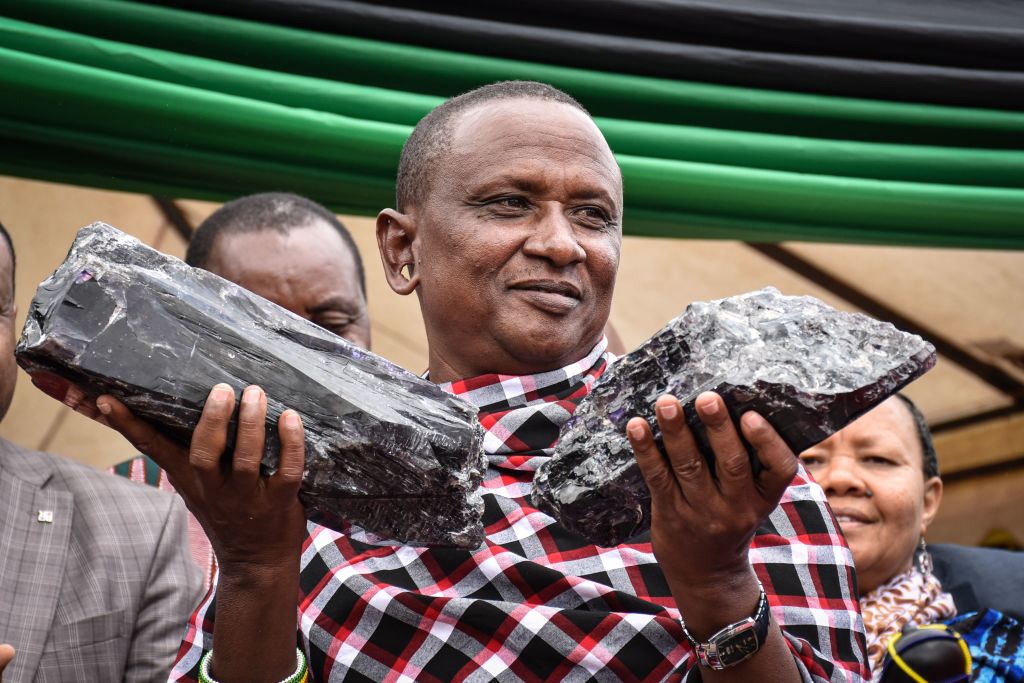 Small-scale miner Saniniu Kuryan Laizer holds the two giant samples of Tanzanite he found at a ceremony honoring his discovery.