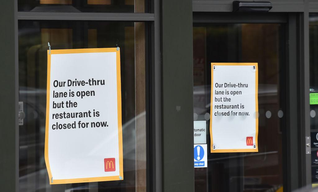 Signs on the doors of a McDonald's restaurant in the U.K. warning customers that the drive through is open but the restaurant itself remains closed due to coronavirus restrictions.