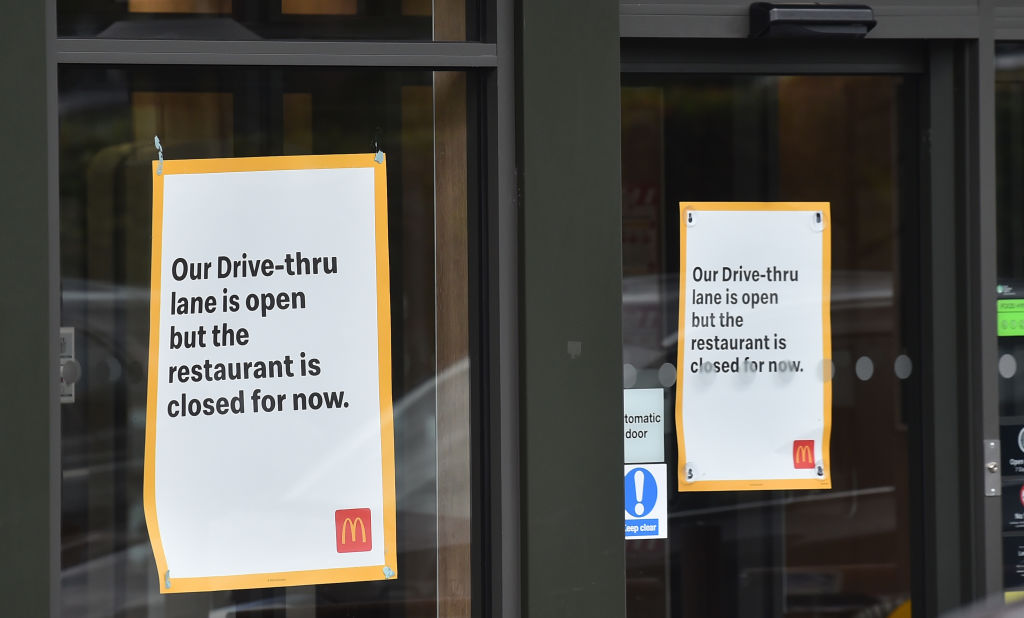 Signs on the doors of a McDonald's restaurant in the U.K. warning customers that the drive through is open but the restaurant itself remains closed due to coronavirus restrictions.