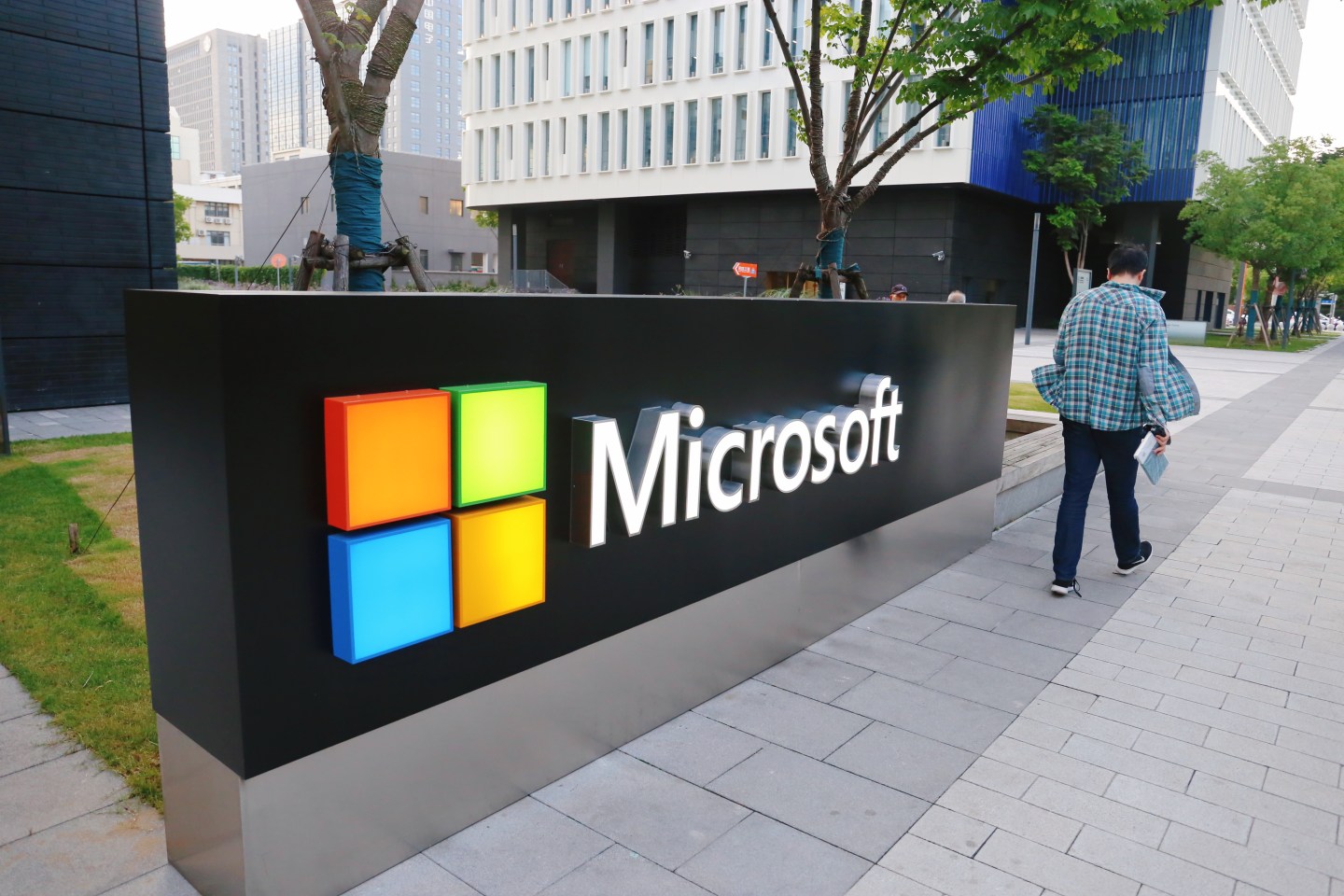 A man walks past a logo of Microsoft outside an office building at Shanghai Caohejing Hi-Tech Park on June 6, 2020 in Shanghai, China.