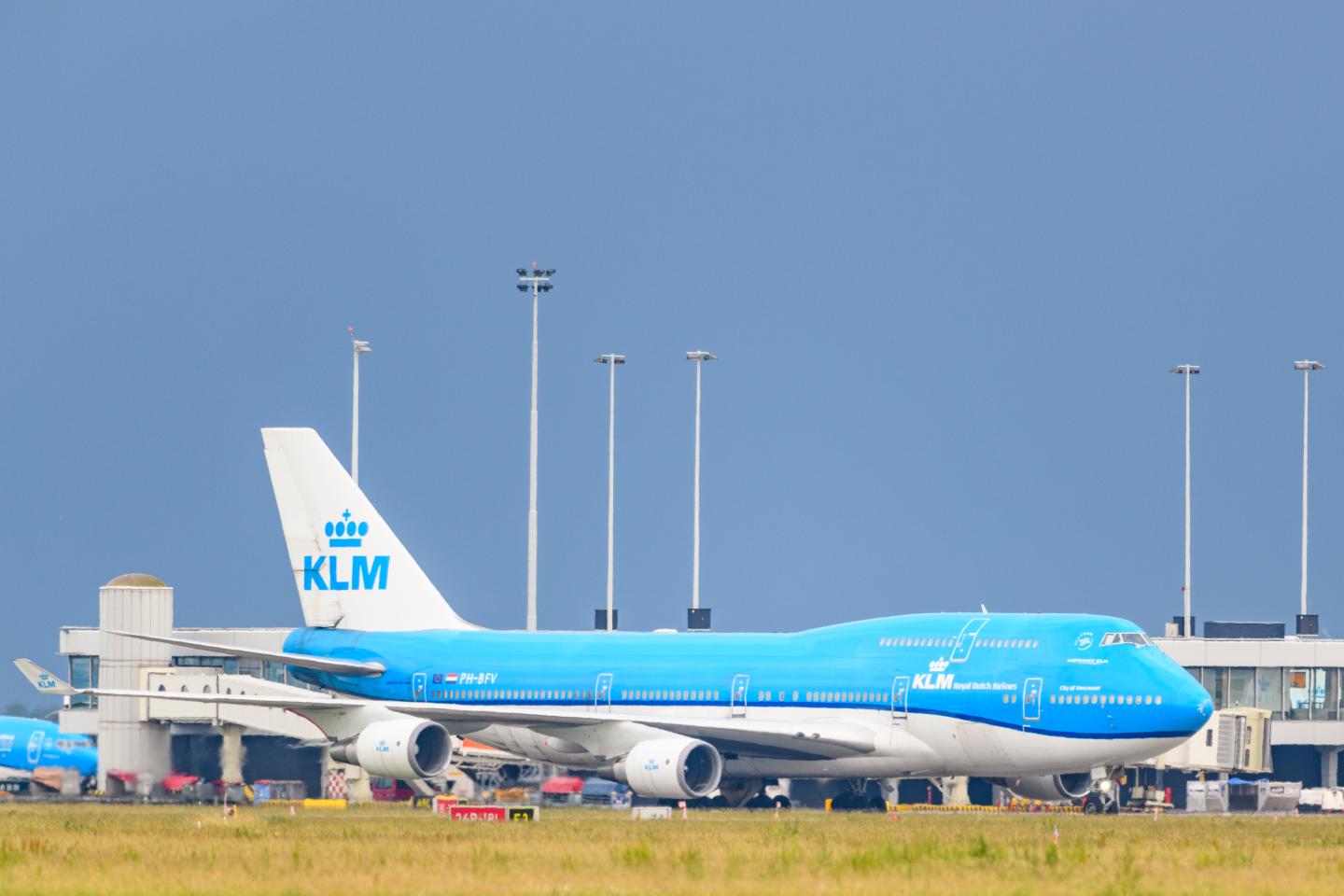 KLM (Koninklijke Luchtvaart Maatschappij - Royal Dutch Airlines) Boeing 747 Jumbojet passing in front of the airfield buildings on June 18 near Amsterdam,Netherlands.