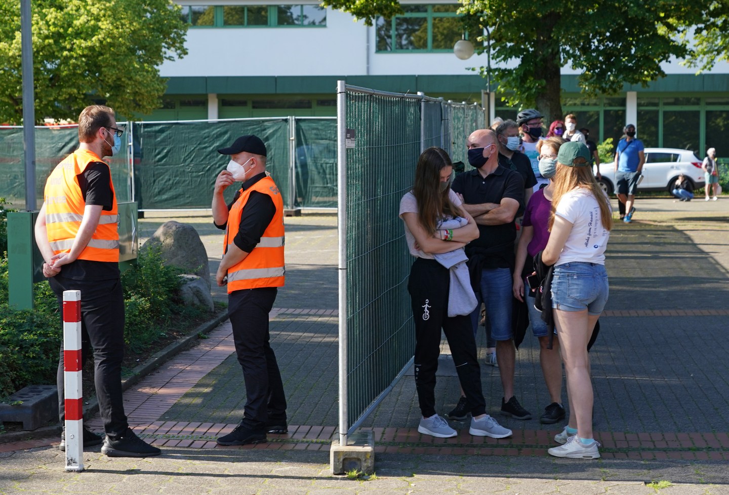 People wait in line to be tested for Covid-19 infection following a Covid-19 outbreak at the nearby Toennies meat packaging center during the coronavirus pandemic on June 24, 2020 in Guetersloh, Germany.