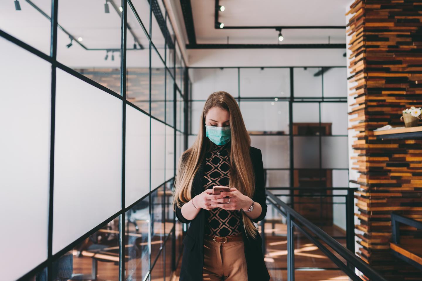 Businesswoman wearing mask in the office during COVID-19 pandemic