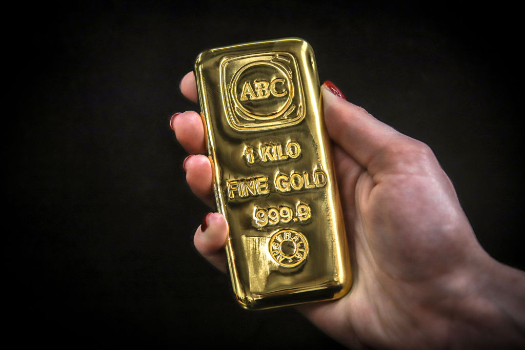 Photo of person holding a gold bar.