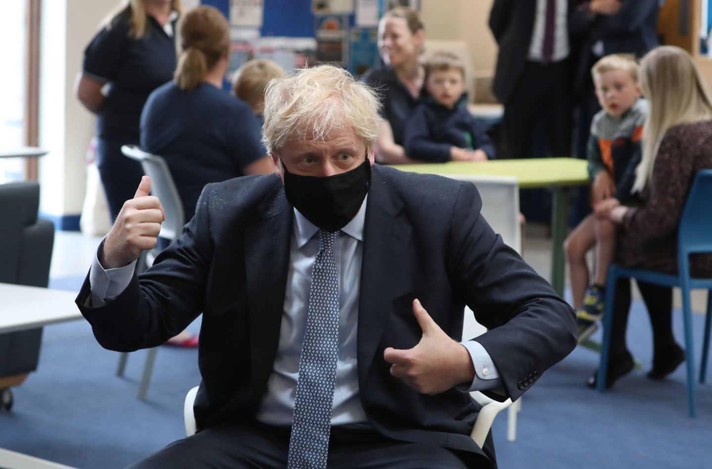 Prime Minister Boris Johnson wears a face mask as he speaks with families in the community centre at RAF Lossiemouth, Moray, during a visit to the Highlands and Northern Isles of Scotland on July 23, 2020 in Lossiemouth, Scotland.