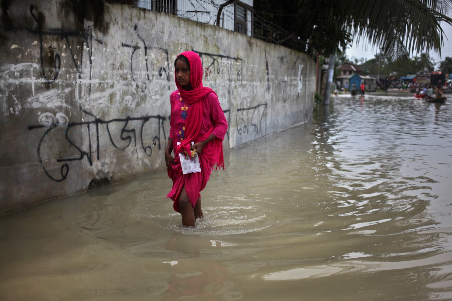 A girl walkthrough floodwater as flood situation worsens at Mawa area in Munshiganj, Bangladesh on Wednesday, July 29,2020.